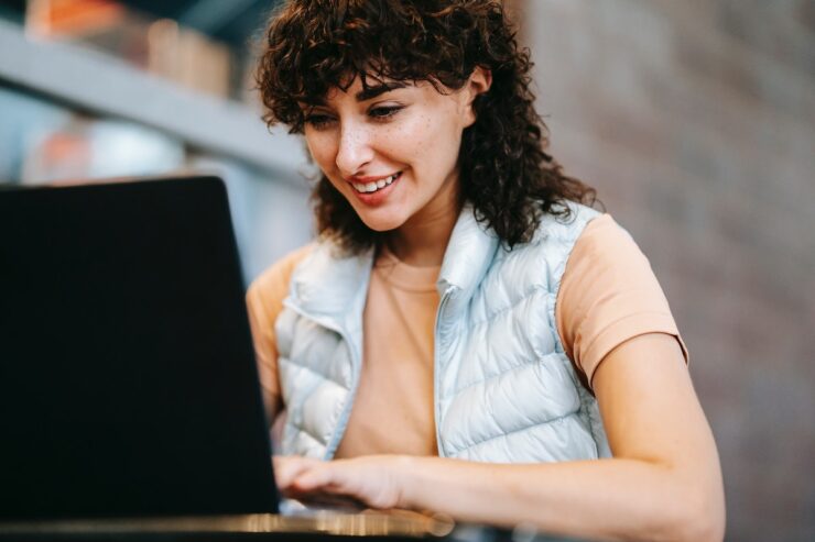 Woman looking at laptop. Online accommodation search